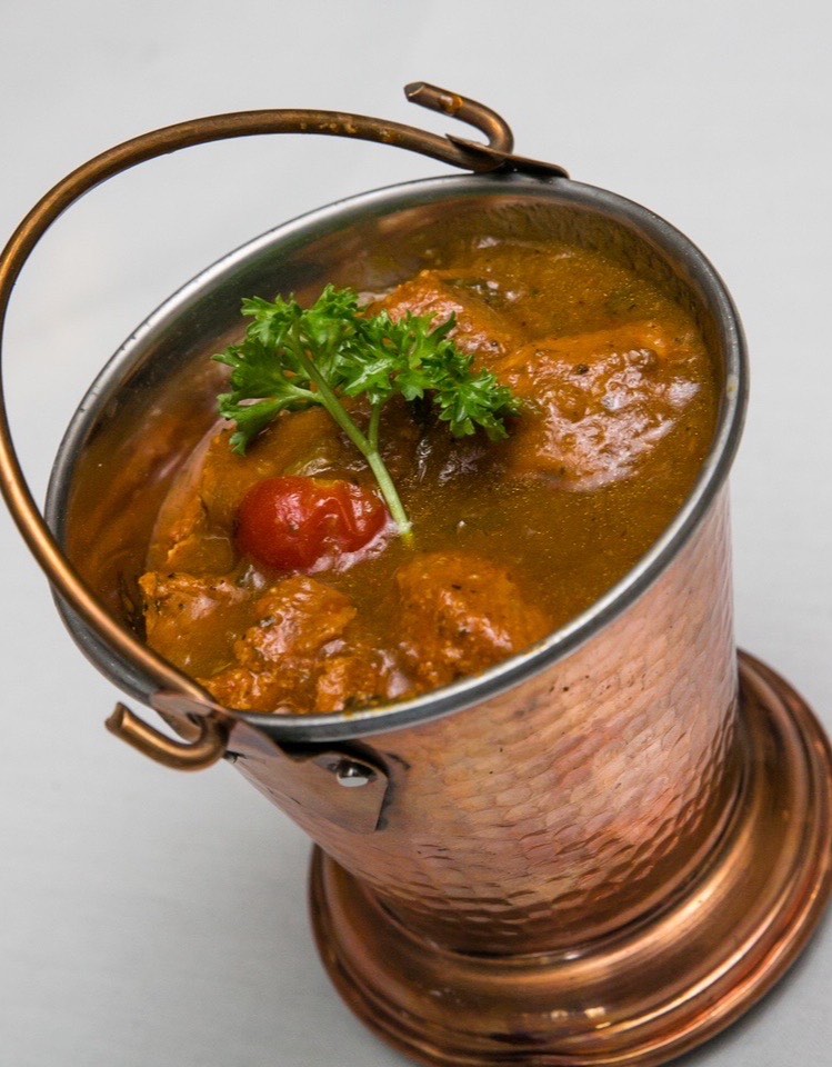 Chicken curry served in a copper balti