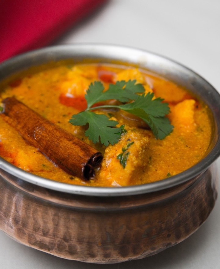 Paneer curry in a steel serving bowl