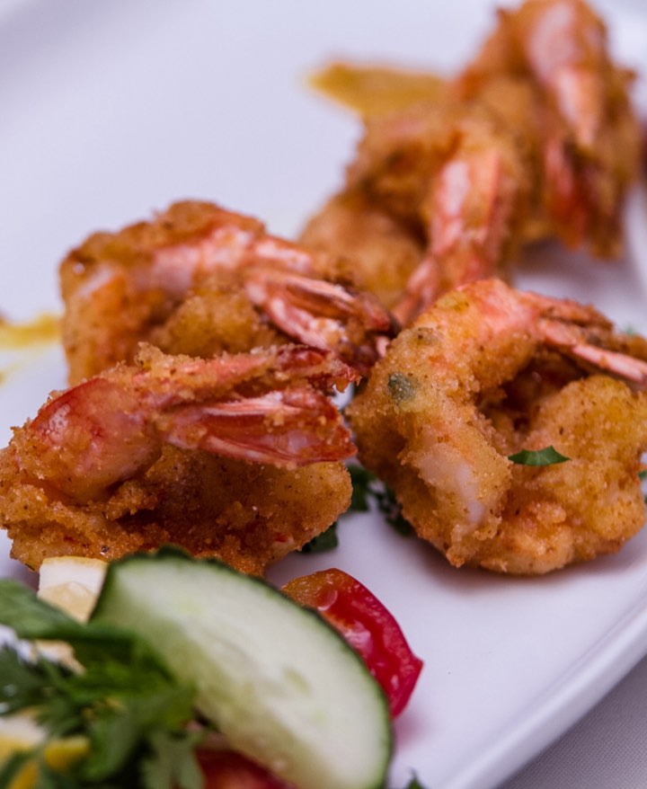 Crispy shrimp plated with tamarind and mint chutney