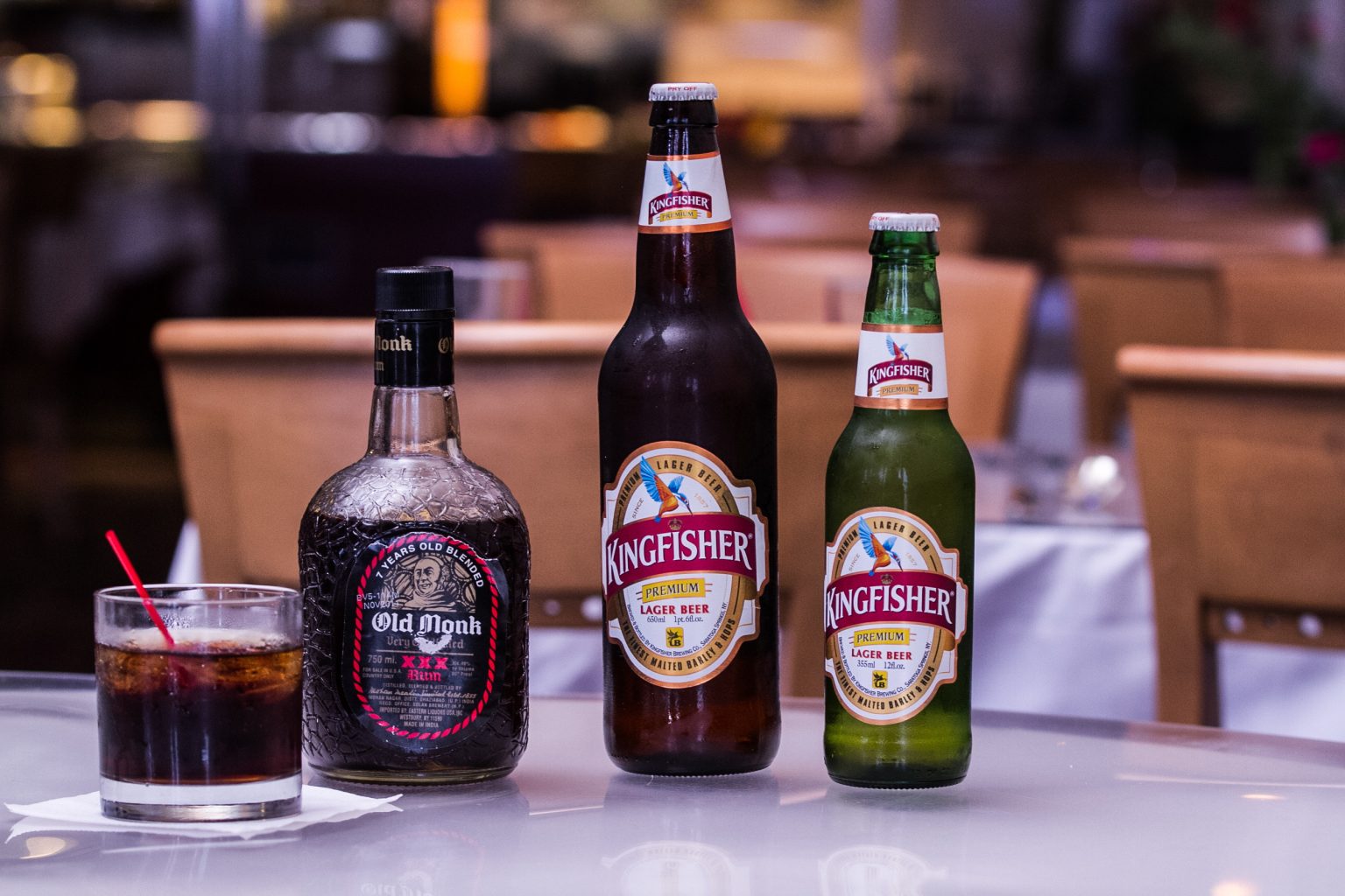 Kingfisher beers and a cocktail on a restaurant table