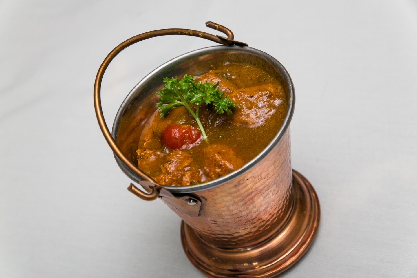 Chicken curry served in a copper balti
