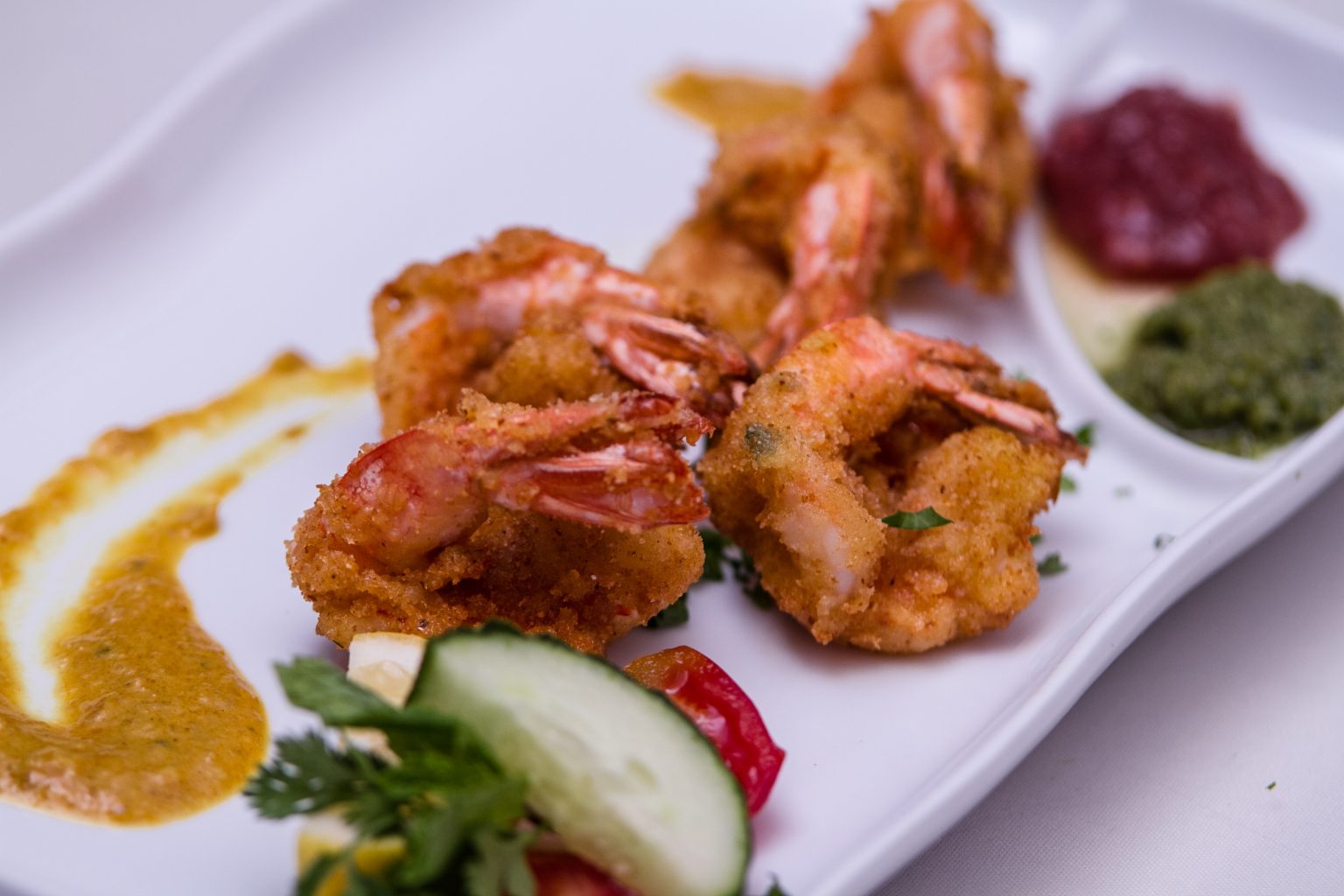 Crispy shrimp plated with tamarind and mint chutney