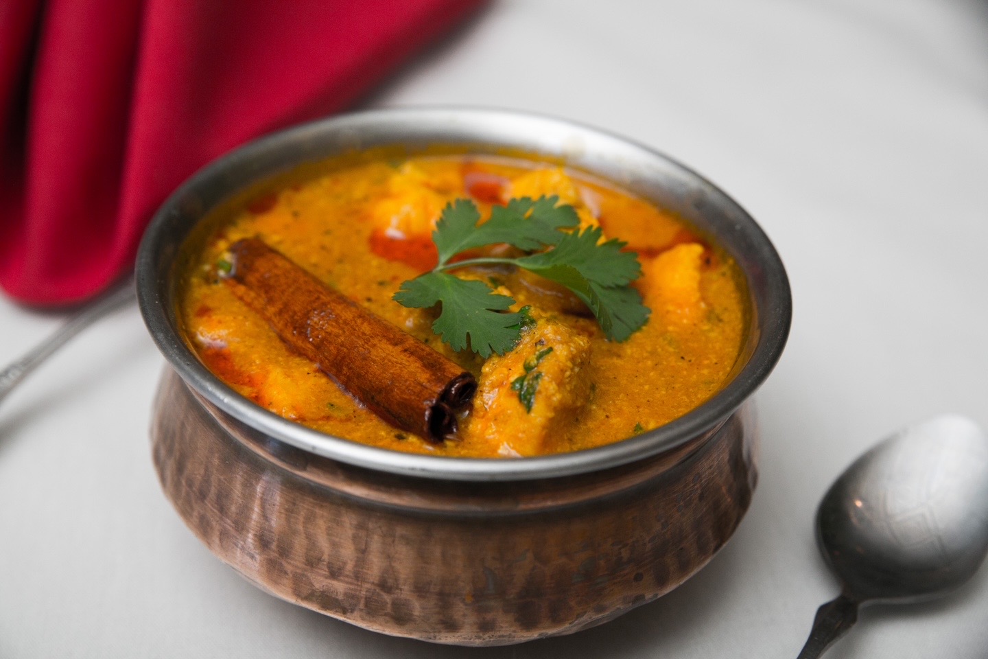 Paneer curry in a steel serving bowl